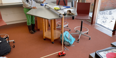 photo shows a constant velocity buggy passing almost perfectly beneath the impact zone of a falling wrecking ball.